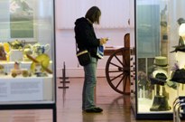 Visitor studying a display at Aberdeen Art Gallery